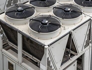 Industrial cooling units with multiple rooftop fans and pipework