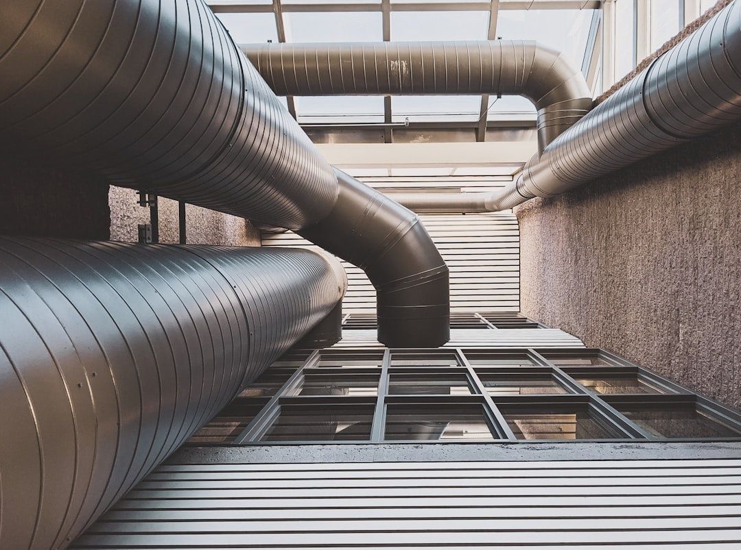 Large insulated HVAC ducts running through an industrial building